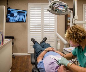 Hygienist working on patient